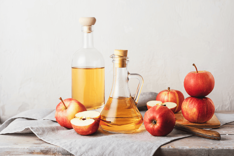 Natural apple cider vinegar and fresh apples.